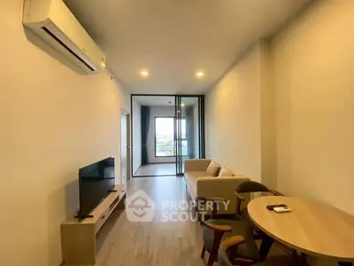 Modern living room with sleek furniture and air conditioning, offering a cozy and inviting atmosphere.