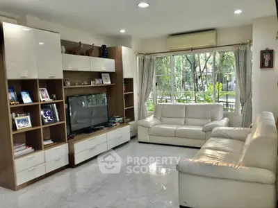 Spacious living room with elegant furniture and large window view