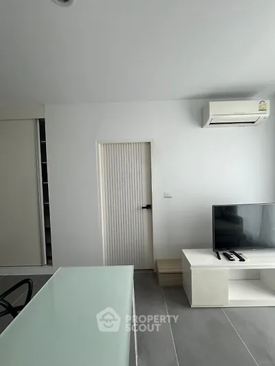 Modern living room with sleek TV stand and air conditioning unit