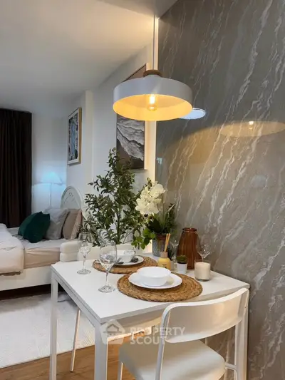 Chic modern studio with elegant dining area and cozy bedroom setup, perfect for urban living.