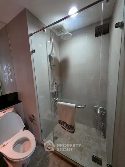 Modern bathroom with glass shower enclosure and sleek fixtures