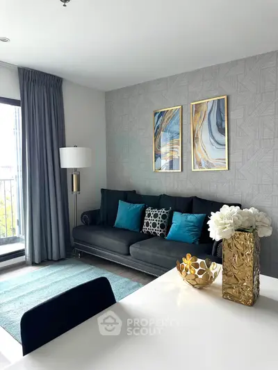 Stylish living room with modern decor, elegant sofa, and artistic wall art in a bright apartment.
