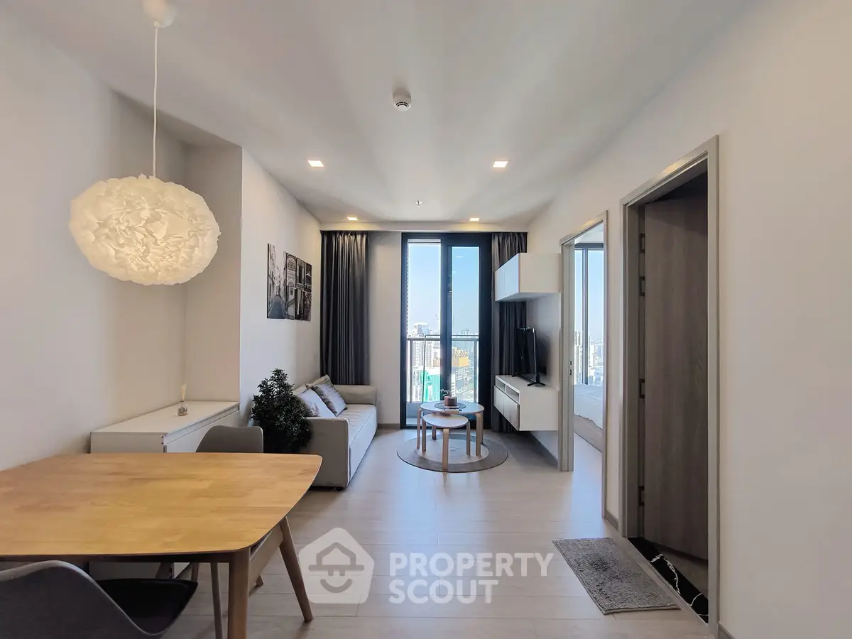 Modern living room with city view, stylish furniture, and natural light