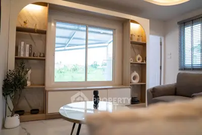 Modern living room with large window and stylish decor, offering a cozy and inviting atmosphere.