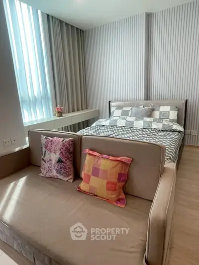 Modern bedroom with stylish decor and cozy seating area