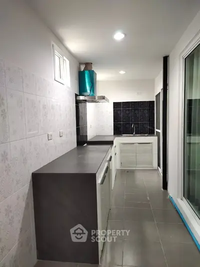 Modern kitchen with sleek countertops and stylish backsplash