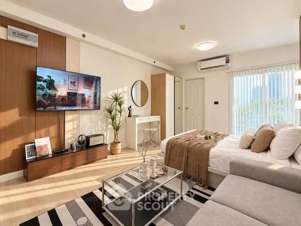 Modern living room with stylish decor, cozy sofa, and large TV, perfect for relaxation and entertainment.