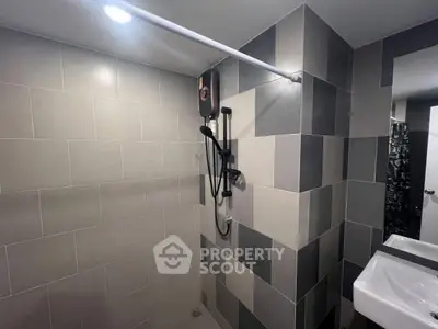Modern bathroom with sleek tile design and contemporary fixtures.