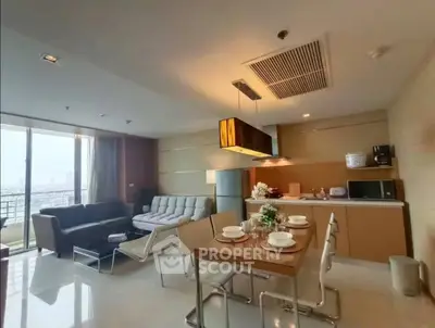 Spacious modern living room with open kitchen and city view, perfect for urban living.
