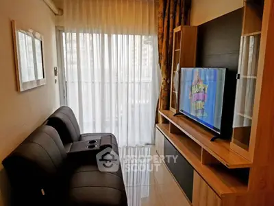 Cozy living room with modern sofa and entertainment unit, perfect for relaxation.