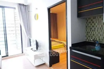 Modern apartment interior with open layout, featuring a cozy living area and stylish kitchen.