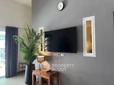 Modern living room with wall-mounted TV and stylish decor