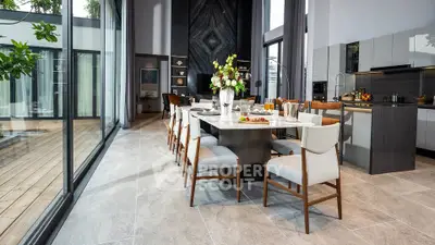 Luxurious modern dining area with elegant decor and large windows overlooking a stylish deck.