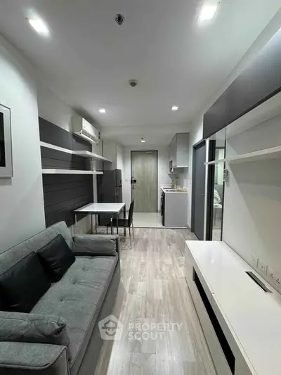 Modern living room with sleek design and open kitchen layout
