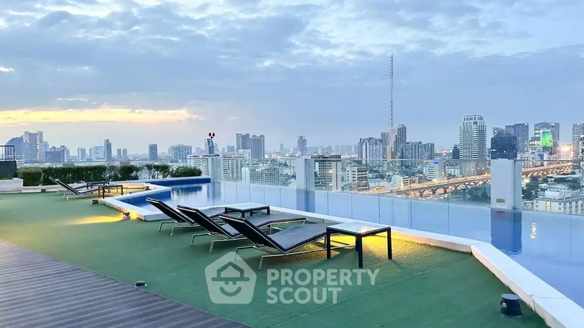 Stunning rooftop pool with city skyline view at sunset