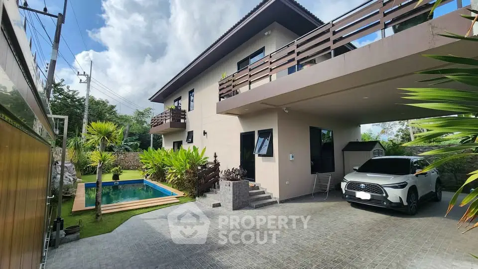 Modern two-story house with carport and pool in lush garden setting
