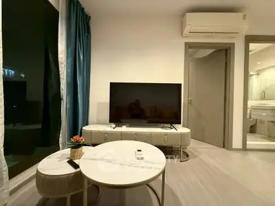 Modern living room with sleek TV setup and elegant furniture, featuring a cozy ambiance.