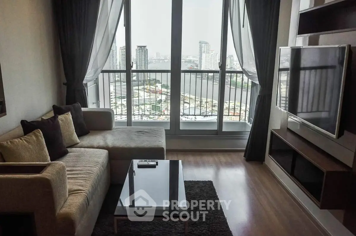 Modern living room with city view, featuring sleek furniture and large windows for natural light.