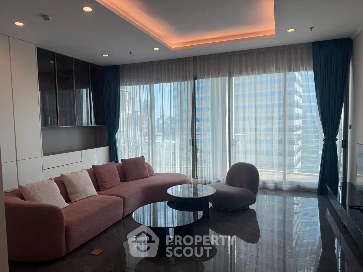 Luxurious modern living room with floor-to-ceiling windows and stylish furniture in a high-rise apartment.