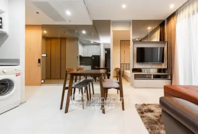 Modern open-plan living room with dining area and washing machine
