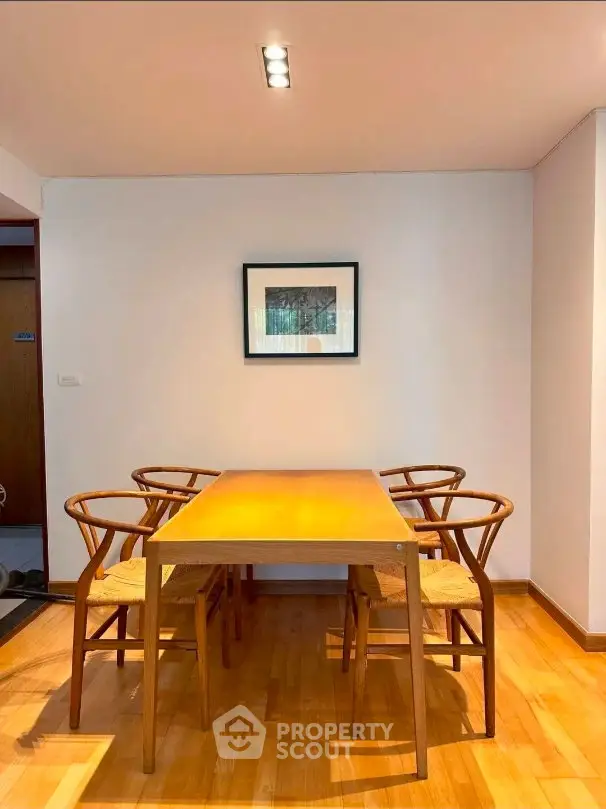 Chic dining area with elegant wooden table and chairs, perfect for modern living.