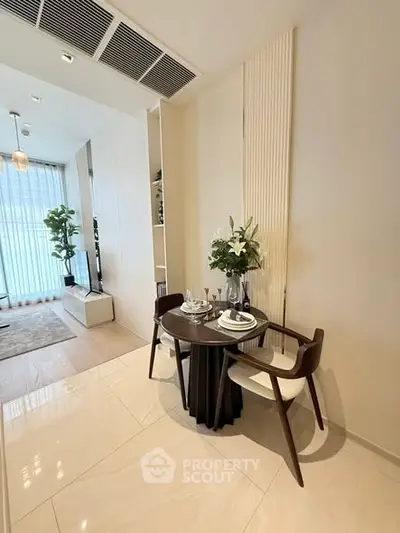 Modern dining area with elegant table setting and stylish decor in a contemporary apartment.