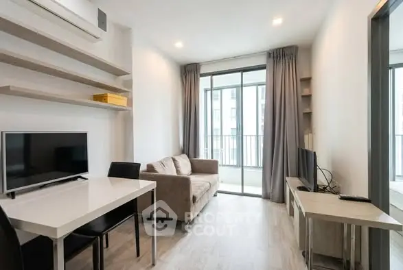 Modern living room with sleek furniture and large windows in a stylish apartment.