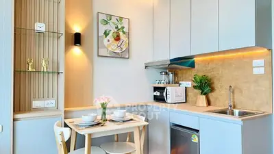 Charming modern kitchen with sleek cabinetry and cozy dining area.