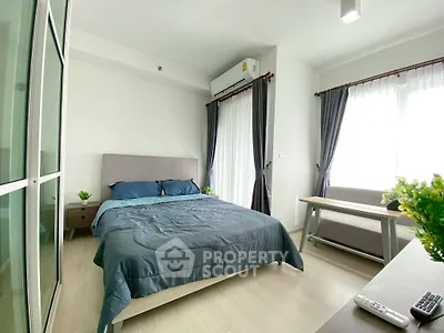 Modern bedroom with natural light, stylish furniture, and cozy ambiance.
