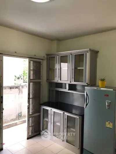 Modern kitchen with sleek cabinets and stainless steel fridge in a bright space.