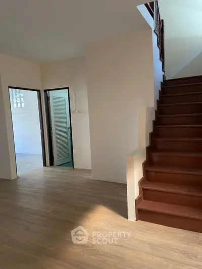Spacious interior with wooden staircase and open layout, perfect for modern living.