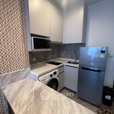 Modern compact kitchen with sleek appliances and stylish backsplash