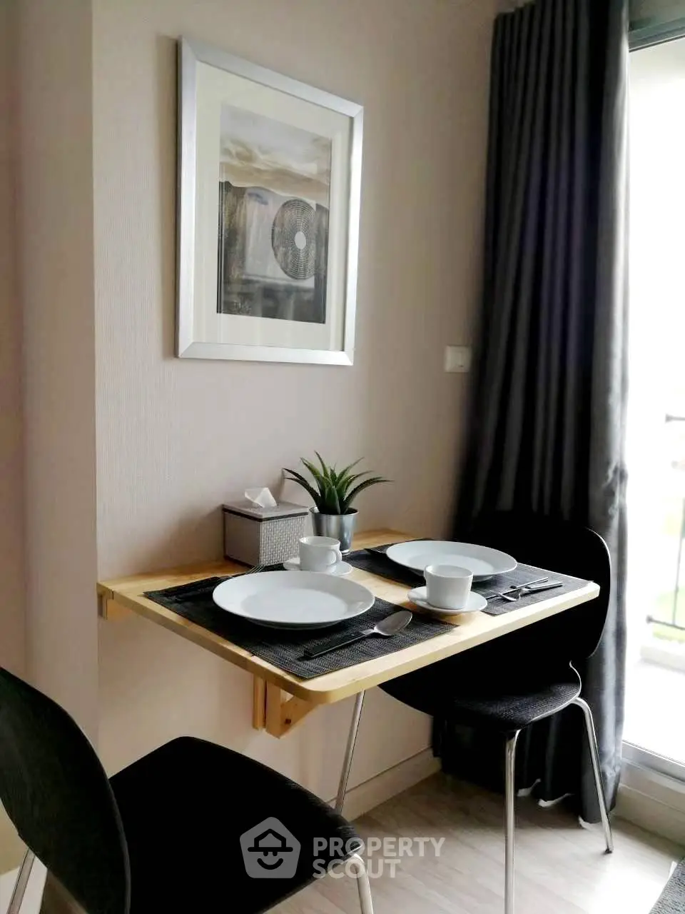Cozy dining nook with modern decor and natural light, perfect for intimate meals.