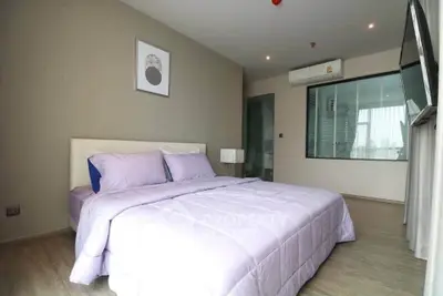 Modern bedroom with stylish decor and large window for natural light