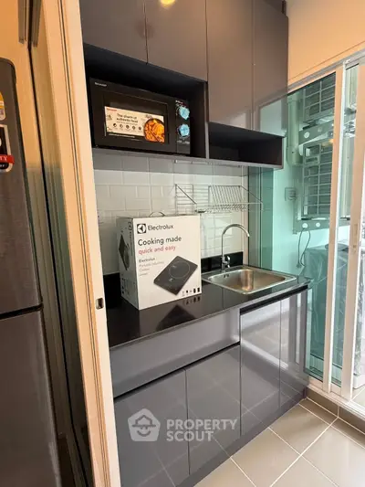 Modern compact kitchen with sleek cabinets and Electrolux appliances