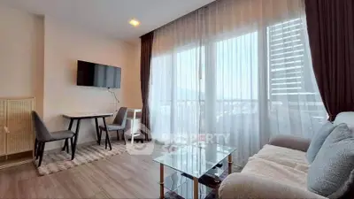 Modern living room with large windows and city view, featuring a cozy sofa and wall-mounted TV.