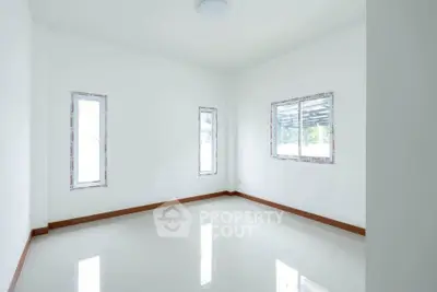Bright empty room with white walls and tiled floor, ready for customization.