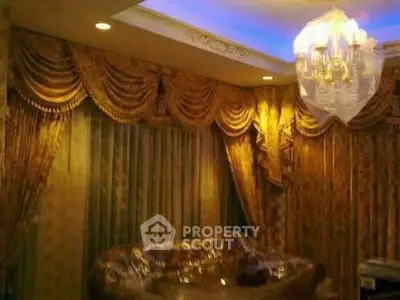Luxurious living room with elegant drapes and chandelier lighting