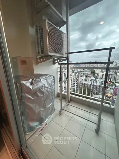 Compact balcony with city view and air conditioning unit, perfect for urban living.