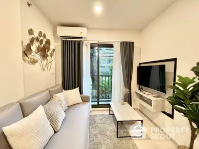 Modern living room with cozy sofa, wall-mounted TV, and garden view through large window.