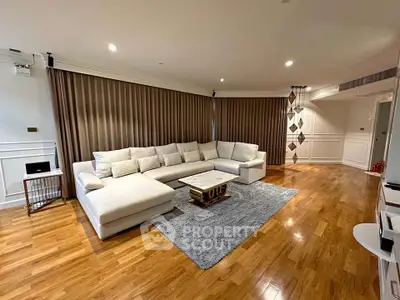 Spacious modern living room with elegant wooden flooring and cozy sectional sofa