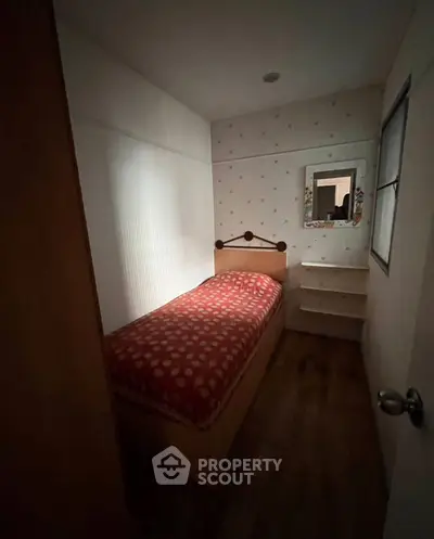 Cozy small bedroom with single bed and decorative mirror