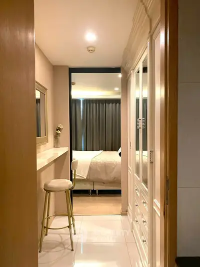 Chic bedroom with elegant decor and cozy ambiance, featuring stylish furniture and soft lighting.