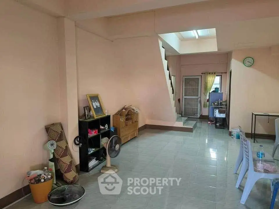 Spacious living area with open layout and staircase, ideal for modern living.