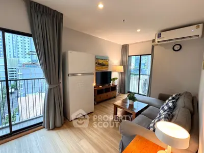 Cozy living room with balcony view, featuring modern furniture and natural light.