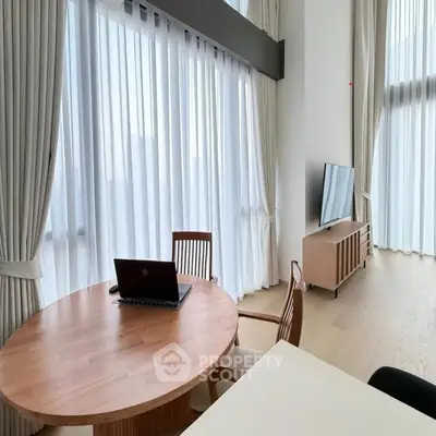 Spacious modern living room with floor-to-ceiling windows and elegant wooden furniture.