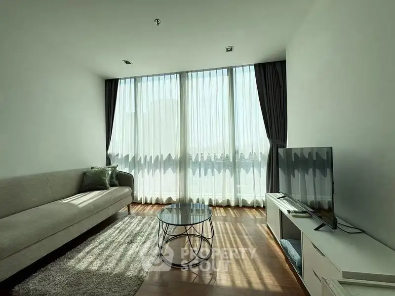 Bright modern living room with large windows and stylish furniture