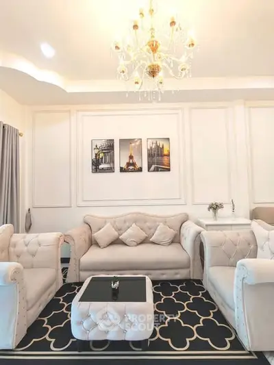 Elegant living room with plush seating and chandelier lighting