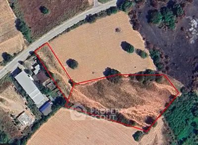 Aerial view of a large plot of land outlined in red, ideal for development or agriculture.