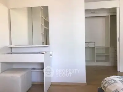 Modern bedroom with built-in closet and sleek vanity area